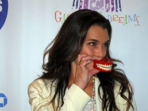 Actress Brooke Shields posing with the Garden of Laughs symbol for the press